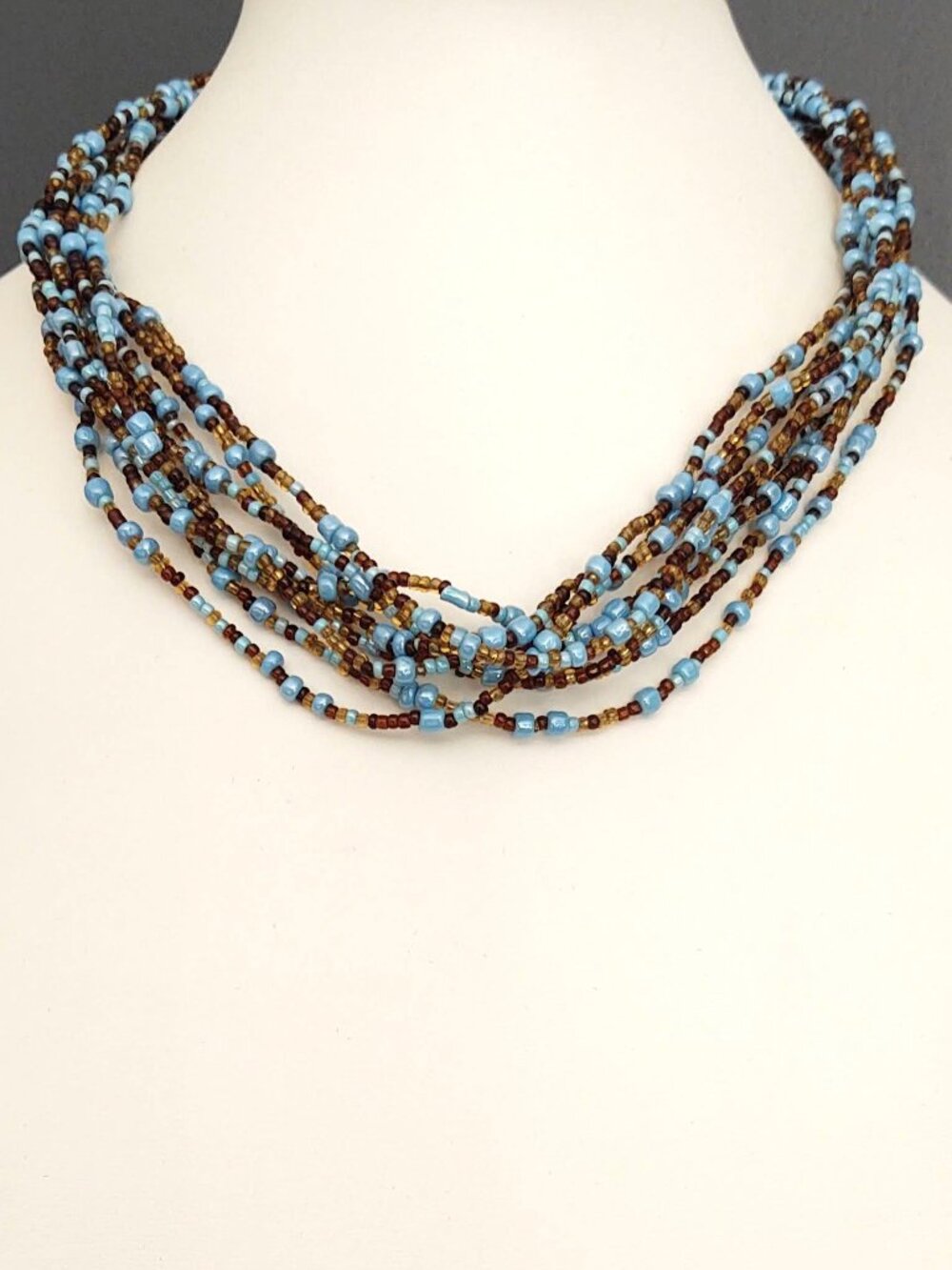 Multi strand seed and tiny bead blue and brown necklace